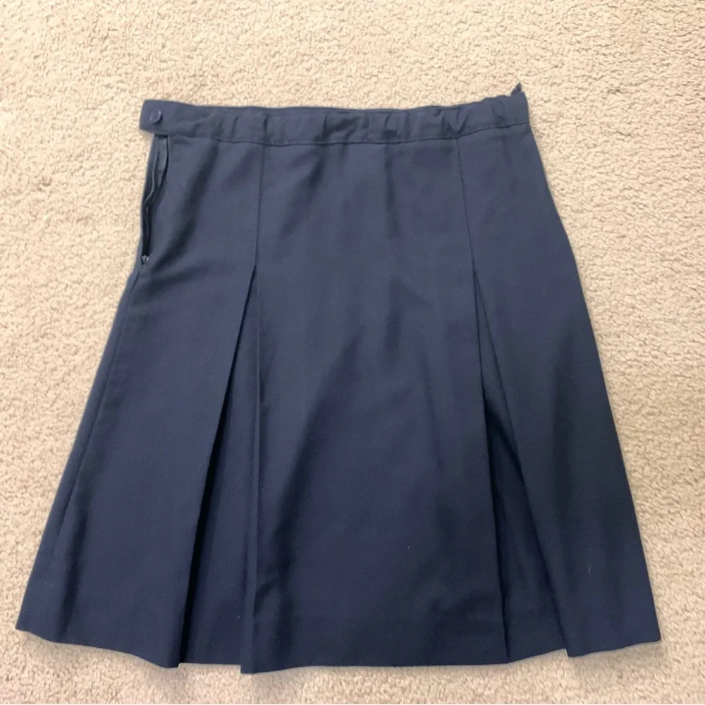 Navy blue pleated skirt with adjustable waist.